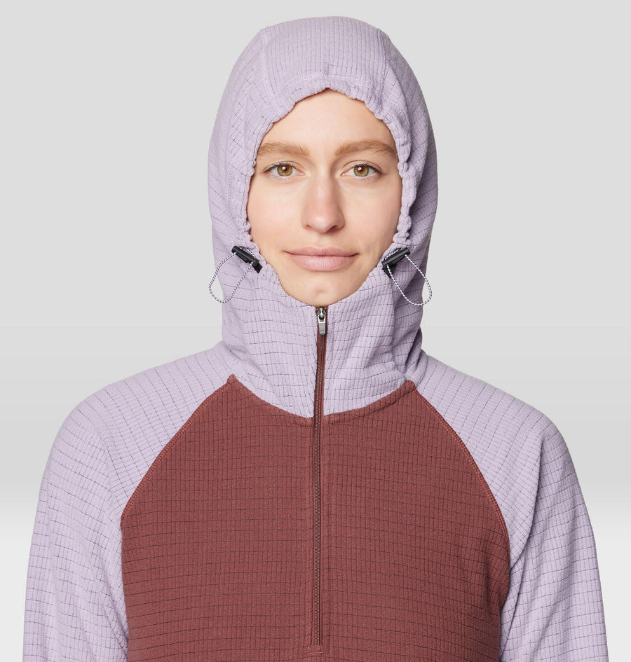 Person wearing a two-tone hoodie with a light purple hood and maroon body on a white background