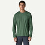 Person wearing a long sleeve green shirt with grey pants against a white background.