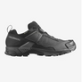 Side view of an all black shoe with grey accents and a Salomon logo on the outer heal of the shoe.