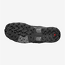 Bottom sole of a shoe that is black and have grey and red accents.