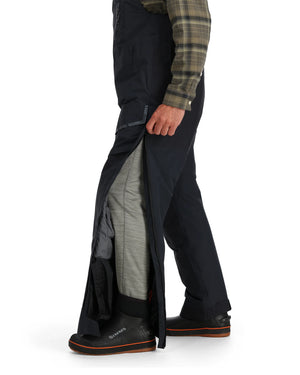 Person wearing Simms Challenger Insulated bibs  plaid shirt, and gray pants on a white background