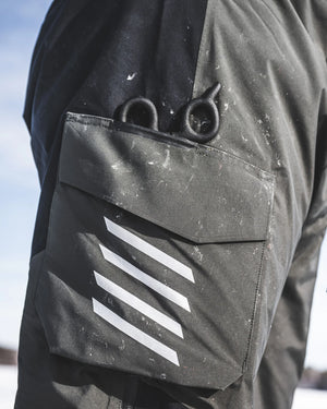 Close-up Simms Challenger Insulated bibs  with a pocket featuring a white stripe design.