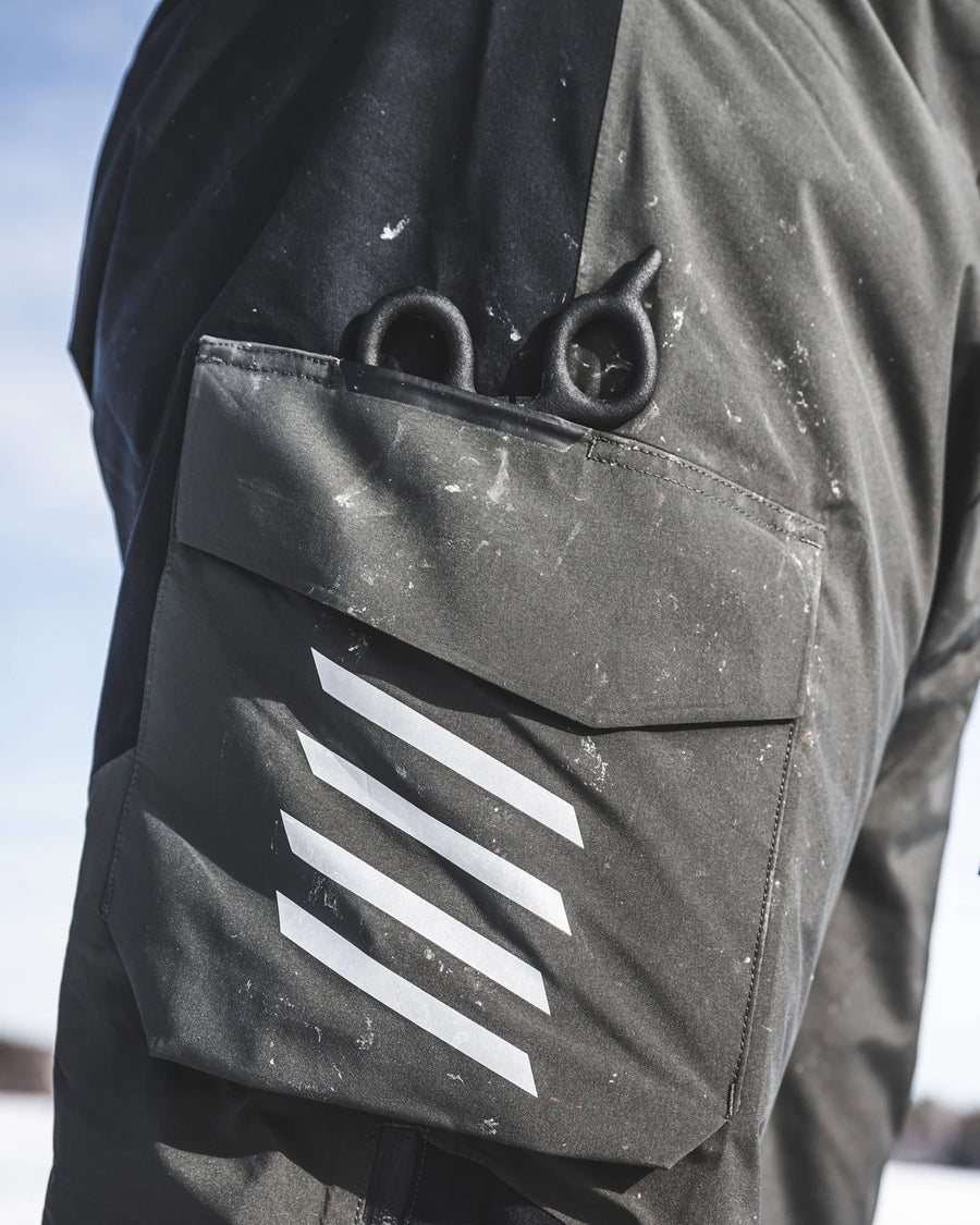 Close-up Simms Challenger Insulated bibs  with a pocket featuring a white stripe design.