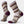 Light purple sock that has dark purple, mustard yellow and blue accents.