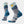 Light grey socks with various shades of blue accents and a night sky line that has a yellow moon.