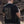 Person wearing a black short sleeve shirt that has an image colored in camo on most of the back of the shirt.