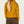 Back view of a person wearing a cropped mustard orange hoody with brown pants against a white background.