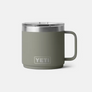 Pale dark green mug with Yeti etched in at the base of the mug against a white background.