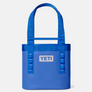 Royal blue tote bag with the Yeti logo in a light grey color on the front of the bag against a white background. 