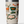Tan Yeti cup with the yeti logo on it and camping images all over it in a green orange and yellow color way against a white background.