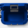 Top view of a Yeti cooler that is blue and is open with a Yeti logo on the latch part against a white background.