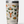 Tan cup with the Yeti logo and camping images all over it, in the colors green, orange and yellow against a white background.