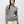 Person wearing a grey and cream colored striped sweater with a cream colored skirt against a white background.