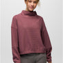 Person wearing a dark mauve sweater with grey pants against a white background.